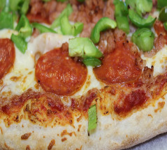 cooked pizza green peppers and pepperoni